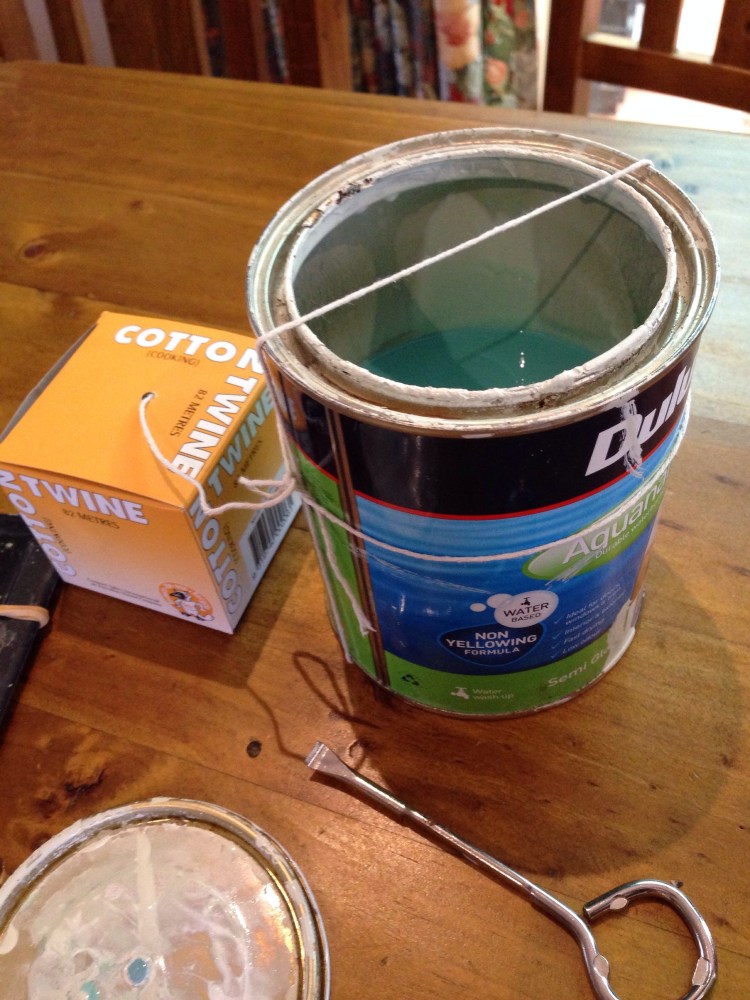 String tied onto paint can.