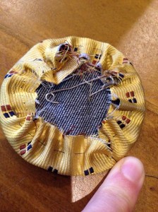 Gathered outer fabric curled over the denim