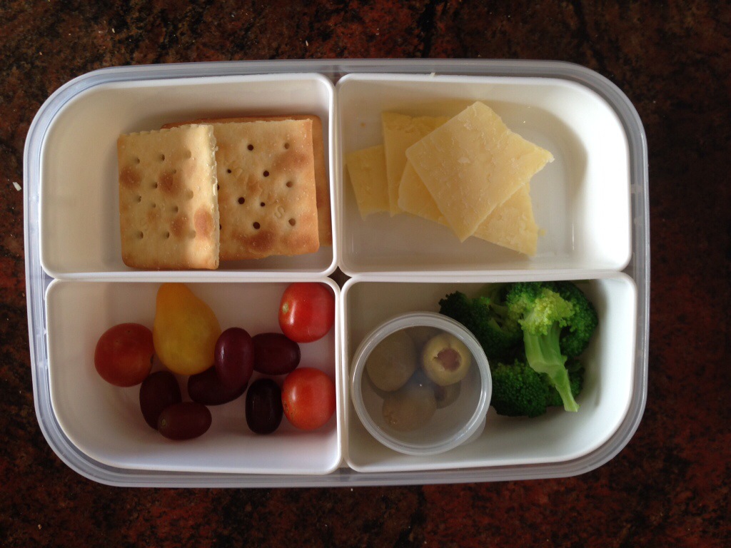 Salada biscuits, cheese, tomatoes, grapes, olives, cooked broccoli