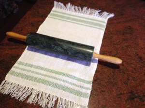 Mangling the towel with a rolling pin.