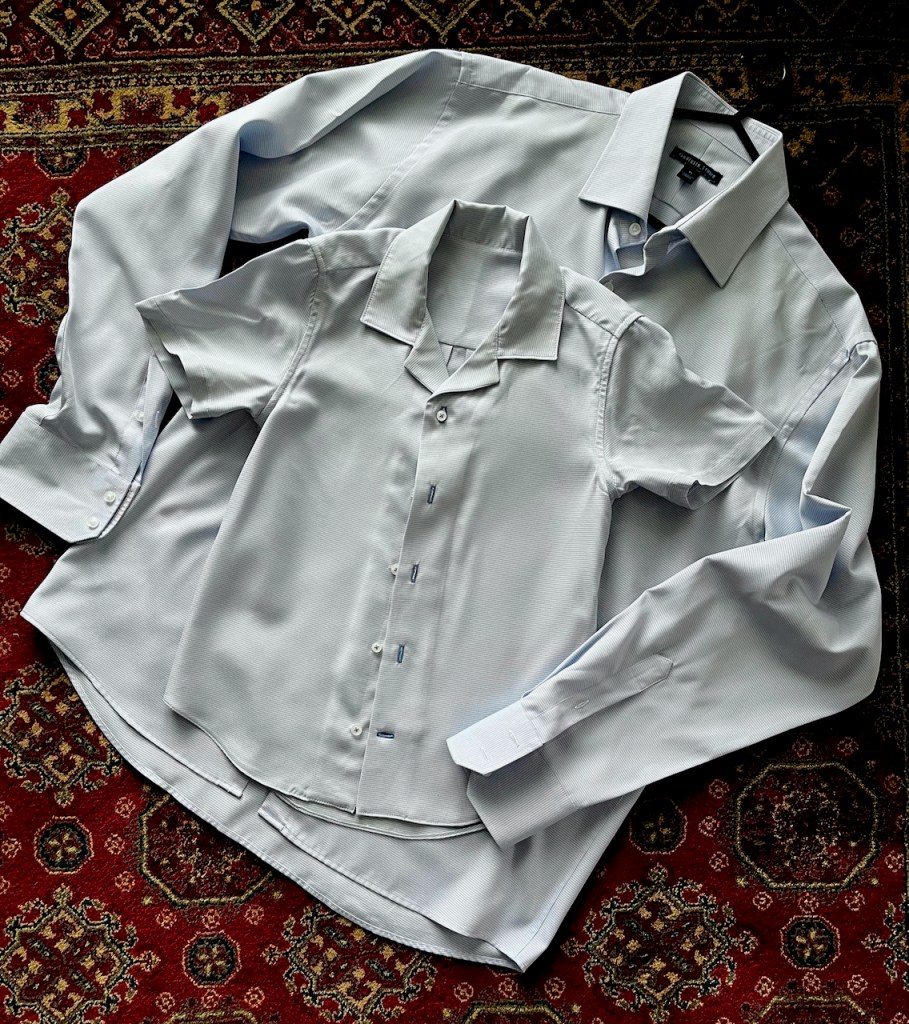 Photo of the new shirt with another men's shirt behind it for size comparison.