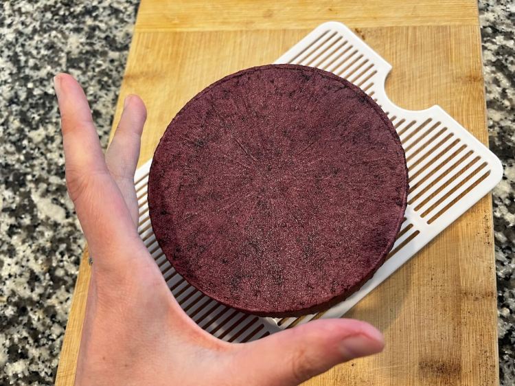 Cheese after second soak, with a hand for scale