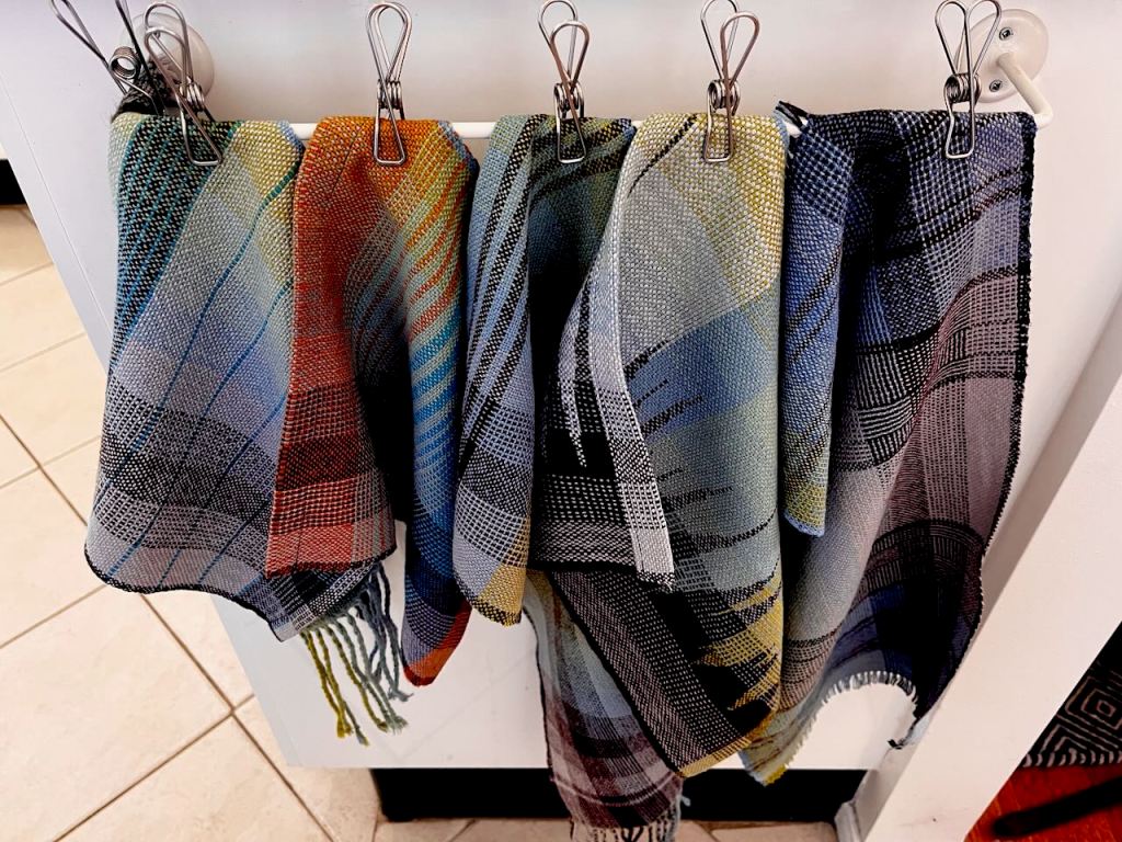 Weaving samples pegged in a line